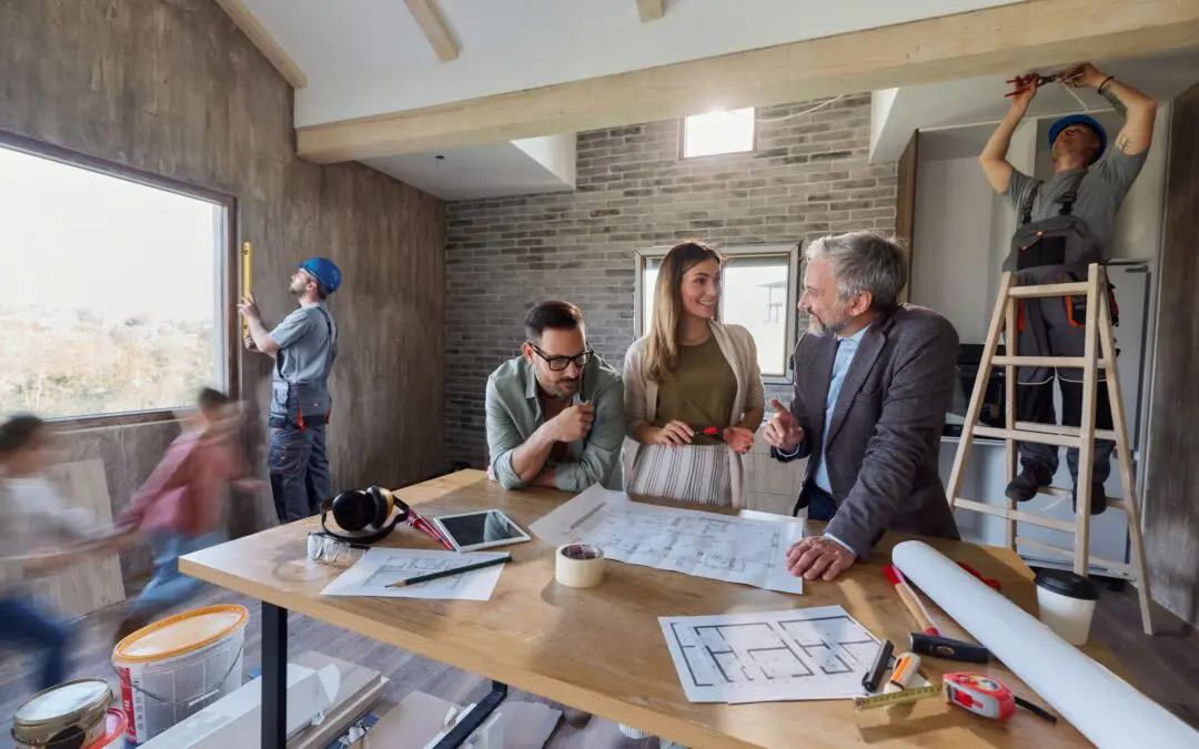 Homeowners reviewing renovation plans with a designer