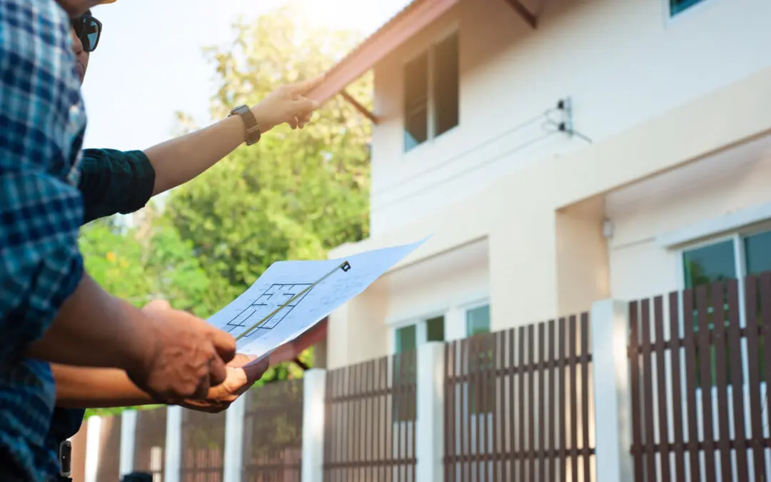Contractor reviewing architectural plans at a job site