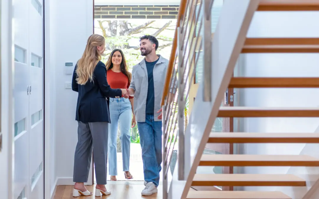 A couple reviewing a home with a real estate agent.